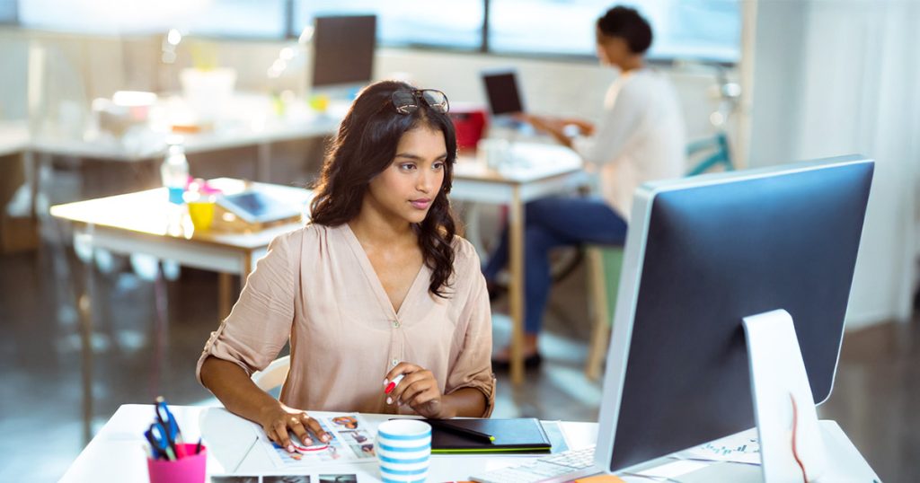 Creative professional collaborating on design and media projects in a modern workspace