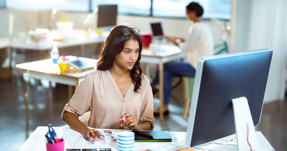 Creative professional collaborating on design and media projects in a modern workspace